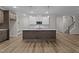 Modern kitchen with stainless steel appliances, a large island and stylish pendant lighting at 20 Diamond Creek Dr, Zebulon, NC 27597