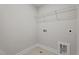 Neutral laundry room with tile floor, wire shelving and washer hookups at 20 Diamond Creek Dr, Zebulon, NC 27597
