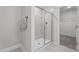 A bright shower with glass doors and tiled walls, situated near a walk-in closet at 20 Diamond Creek Dr, Zebulon, NC 27597