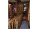 Charming hallway with wood-paneled walls, rustic staircase, and inviting doorways at 207 High House Rd, Cary, NC 27513