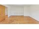 Bedroom with hardwood floors, white walls, and built-in shelving at 209 High House Rd, Cary, NC 27513