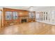 Bright living room with wood paneling, brick fireplace, and unique mirror wall at 209 High House Rd, Cary, NC 27513