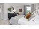 Bright bedroom featuring a comfy bed, dresser with round mirror, and ample natural light at 2148 Monk Dr, Haw River, NC 27258