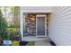 Home's inviting entryway features a stone surround and stylish front door at 2148 Monk Dr, Haw River, NC 27258