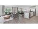 Bright living room features large windows and seamlessly connects to the kitchen at 2148 Monk Dr, Haw River, NC 27258