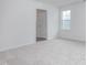 A bedroom with white walls, carpet flooring, and a window letting in natural light at 2160 Monk Dr, Haw River, NC 27258