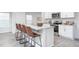 Modern kitchen island with stainless steel appliances, white cabinets, granite countertops, and bar stool seating at 2160 Monk Dr, Haw River, NC 27258
