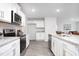 Modern kitchen with white cabinets, granite countertops, and stainless steel appliances at 2160 Monk Dr, Haw River, NC 27258