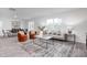 Spacious living room featuring stylish seating and decor, open to dining area with sliding glass door at 2160 Monk Dr, Haw River, NC 27258