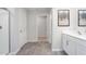 Modern bathroom with double white sink vanity, framed mirror, and vinyl plank flooring at 2168 Monk Dr, Haw River, NC 27258