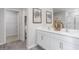 Bathroom featuring double sink vanity, modern faucets, and neutral gray vinyl plank flooring at 2168 Monk Dr, Haw River, NC 27258