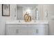 Bathroom featuring double sink vanity, modern faucets, and framed mirror at 2168 Monk Dr, Haw River, NC 27258