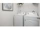 A laundry room with a white washer and dryer set and wire shelving at 2168 Monk Dr, Haw River, NC 27258