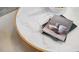 Close-up of a marble-topped coffee table adorned with books at 2168 Monk Dr, Haw River, NC 27258