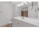 Well-lit bathroom with large mirror, a tiled shower, and white vanity at 222 Glenwood Avenue # 218, Raleigh, NC 27603