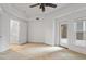 Large bedroom with doors leading to a closet and a private balcony at 222 Glenwood Avenue # 218, Raleigh, NC 27603