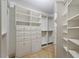 Spacious walk-in closet with custom shelving and drawers for optimal organization at 222 Glenwood Avenue # 218, Raleigh, NC 27603