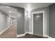 Hallway view featuring neutral color palette and carpet, leading to unit doors at 222 Glenwood Avenue # 218, Raleigh, NC 27603