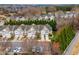 Aerial view of townhome community with parking and mature landscaping at 2302 Wispy Green Ln, Raleigh, NC 27614