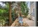Outdoor stone patio offers a tranquil space with a table, chairs, and lush tree surroundings at 2302 Wispy Green Ln, Raleigh, NC 27614
