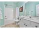 A clean, simple bathroom with a shower/tub combo and a white vanity with a large mirror at 2302 Wispy Green Ln, Raleigh, NC 27614