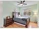 Well-lit bedroom featuring a ceiling fan, a dark wood bed frame and matching dresser at 2302 Wispy Green Ln, Raleigh, NC 27614