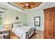 A serene bedroom with a decorative ceiling, hardwood floors, and ample natural light from multiple windows at 2302 Wispy Green Ln, Raleigh, NC 27614
