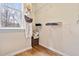 A tidy closet with ample shelving, hardwood floors, and natural light from a window at 2302 Wispy Green Ln, Raleigh, NC 27614