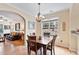 Cozy dining area with hardwood floors, chandelier, and views into the living room at 2302 Wispy Green Ln, Raleigh, NC 27614