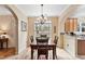 Inviting dining area with hardwood floors, chandelier, and open access to the kitchen at 2302 Wispy Green Ln, Raleigh, NC 27614