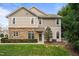 Charming two-story home with a combination of stone and siding, complemented by lush landscaping at 2302 Wispy Green Ln, Raleigh, NC 27614