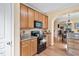 A well-equipped kitchen with granite countertops, wood cabinets, a built-in microwave, and hardwood floors at 2302 Wispy Green Ln, Raleigh, NC 27614
