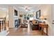 Bright living room features hardwood floors, fireplace, and a large window for natural light at 2302 Wispy Green Ln, Raleigh, NC 27614