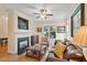 Cozy living room with fireplace, hardwood floors, and a comfortable leather sofa at 2302 Wispy Green Ln, Raleigh, NC 27614