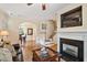 Open-concept living room with hardwood floors, fireplace, and dining area beyond arched doorway at 2302 Wispy Green Ln, Raleigh, NC 27614