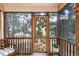 Inviting screened porch featuring wood framework and stone patio, providing a serene outdoor space at 2302 Wispy Green Ln, Raleigh, NC 27614