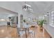 Bright living room featuring hardwood floors, white walls, vaulted ceiling, and modern lighting fixtures at 2403 June Dr, Hillsborough, NC 27278