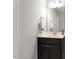 Half bathroom featuring a dark vanity with sink and a mirror at 244 Winding Oak Way, Clayton, NC 27520