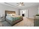 Comfortable bedroom showcasing tray ceilings, a ceiling fan, and neutral color scheme at 244 Winding Oak Way, Clayton, NC 27520