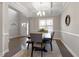 Elegant dining room with coffered ceilings, stylish chandelier, and modern decor at 244 Winding Oak Way, Clayton, NC 27520