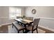 Dining room with a dark wood table, gray upholstered chairs, and neutral decor at 244 Winding Oak Way, Clayton, NC 27520