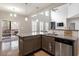 Gourmet kitchen features stainless appliances, island and flows into living space at 244 Winding Oak Way, Clayton, NC 27520