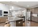 Open concept kitchen with stainless steel appliances, island, and hardwood floors at 244 Winding Oak Way, Clayton, NC 27520