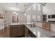 Gourmet kitchen features stainless appliances, island and flows into living space at 244 Winding Oak Way, Clayton, NC 27520