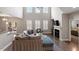 Bright living room with vaulted ceilings, a fireplace, and an adjacent bedroom at 244 Winding Oak Way, Clayton, NC 27520