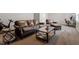 A living room with brown leather furniture, side tables and a wood-framed coffee table at 244 Winding Oak Way, Clayton, NC 27520