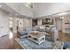 Open-concept living room with hardwood floors and views into kitchen area at 244 Winding Oak Way, Clayton, NC 27520