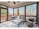 Screened-in porch with seating for 5 and views of the wooded backyard at 244 Winding Oak Way, Clayton, NC 27520
