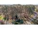 Aerial shot of a home surrounded by lush greenery and mature trees at 2501 Huntsman Trl, Zebulon, NC 27597