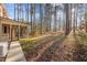 Expansive backyard featuring a wooded lot and covered porch, perfect for enjoying nature at 2501 Huntsman Trl, Zebulon, NC 27597